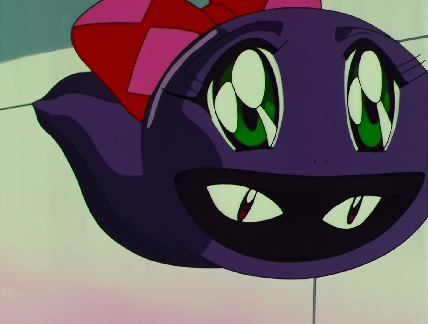 KeroKero Musume, a Lemures from Sailor Moon episode 151. To begin with, she’s a floating, chubby black tadpole with cutesy eyes and a large red bow, but a second set of eyes is visible inside her mouth.
